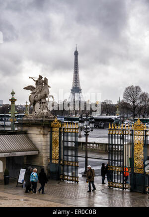 Paris, Place de la Concorde, Eiffel Tower and equestrian statue of Fame riding Pegasus at Tuileries garden gates Stock Photo