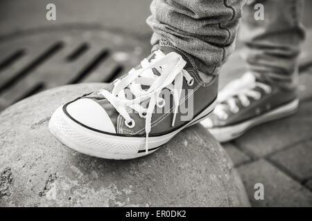 Brand new shoes, urban walking theme. Black and white photo with selective focus and shallow DOF Stock Photo