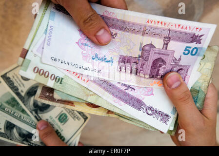 Iranian rials and American dollars, Tehran, Iran. Stock Photo