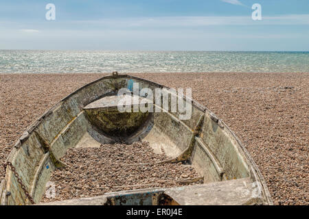 Rusty fishing boat on the beach in front of the Brighton Fishing Museum on Brighton's seafront, Sussex, England, UK. Stock Photo