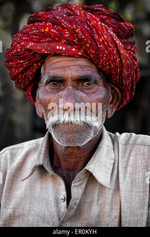 Indian man with moustache in traditional colourful turban portrait Pushkar, India. March 3, 2013 Stock Photo