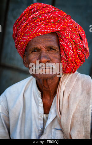 Indian man with moustache in traditional colourful turban portrait Pushkar, India. March 3, 2013 Stock Photo