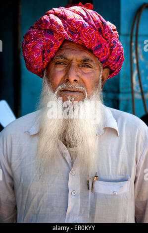 Indian man with white beard in traditional colourful turban portrait Pushkar, India. March 6, 2013 Stock Photo