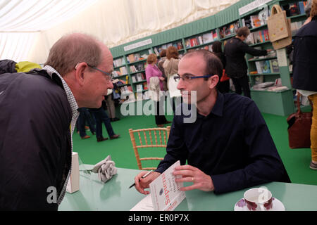 Powys, Wales, UK May 2015 Author Yuval Noah Harari in the Festival bookshop signing copies of his latest book Sapiens - A Brief History of Humankind. Stock Photo