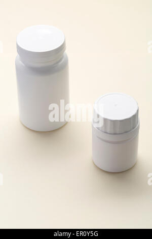 Plastic medical bottle on a beige background Stock Photo