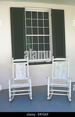 A pair of white antique rocking chairs await visitors to Melrose, an Old South antebellum mansion in Natchez, Mississippi, USA. Stock Photo