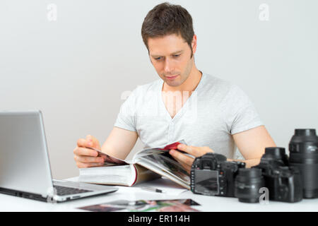 Photographer working in his office. Stock Photo