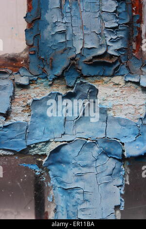 Paint peeling off the painted glass of a weathered wooden window Stock ...