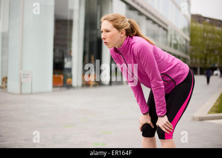 young runner catching her breath Stock Photo