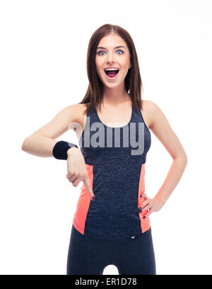 Surprised fitness woman pointing finger down isolated on a white background. Looking at camera Stock Photo