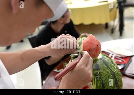 Beijing, China. 25th May, 2015. A chef decorates his watermelon carving during the 27th Daxing Watermelon Festival in Panggezhuang Township of Daxing District of Beijing, capital of China, May 25, 2015. Credit:  Gao Jianjun/Xinhua/Alamy Live News Stock Photo