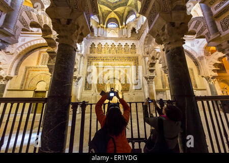 Cordoba, Cordoba Province, Andalusia, southern Spain.  Two visitors taking photos of the Mihrab in La Mezquita, or Great Mosque. Stock Photo