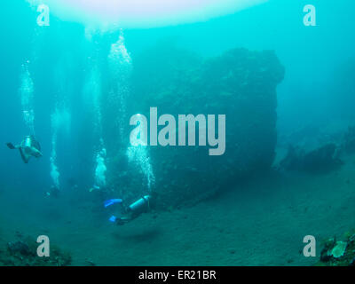 Group of scuba divers exploring the famous ship wreck USS Liberty at Tulamben on Bali, Indonesia Stock Photo