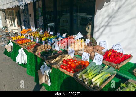 A traditional greengrocer's shop with pavement display in Bridport, Dorset, England, UK Stock Photo