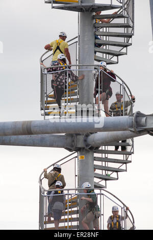 Climbing up spiral staircase to the top of the launch tower to try out the pier zipwire on Bournemouth Pier, Dorset in May Stock Photo