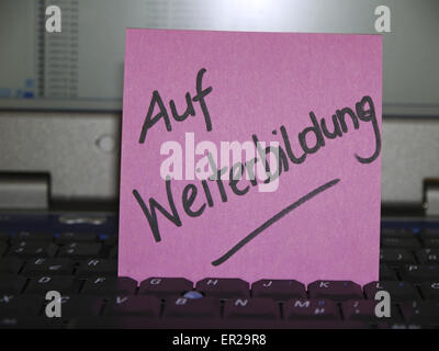 Memo note on notebook, on further education, training Stock Photo