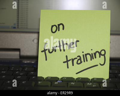 Memo note on notebook, on further training Stock Photo