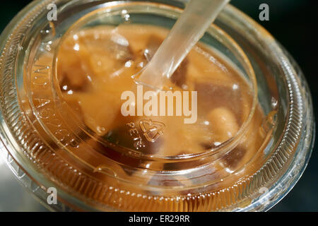 https://l450v.alamy.com/450v/er29rr/iced-coffee-in-a-plastic-container-a-typical-warm-weather-nyc-drink-er29rr.jpg