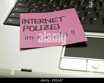 Memo note on notebook, internet police in service Stock Photo