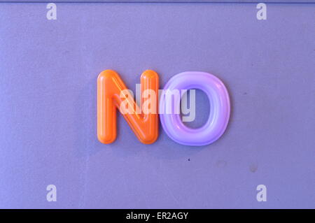 Colored magnetic letters on blue fridge to say No Stock Photo