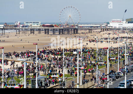 British seaside resort, Blackpool, Lancashire, UK. 25th May, 2015. Crowded beach, pier and amusements on the summer resort seashore, people, crowd, holiday, sea, travel, fun, sun, vacation, sand, water, outdoors, joy, tourism, landscape, festival, party, adult, shore, coastline of the north-west of England. Stock Photo