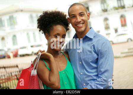Portrait of black tourist heterosexual couple in Casco Antiguo - Panama City with shopping bags. The man and his girlfriend smil Stock Photo