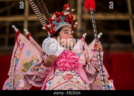 Cheung Chau Island. 25th May, 2015. A child dressed in costume waits to perform on floats ahead of the Piu Sik Parade at Bun Festival in Cheung Chau Island on May 25, 2015 in Hong Kong. One of Hong Kong's most colourful cultural celebration events, Cheung Chau Bun Festival, will be staged on 25 May 2015 until 26th May 2015 midnight. Every year, thousands of people descend upon the tiny island for The Piu Sik Parade, Lucky Bun and The Bun Scrambling Competition, the ancient custom during the festival. The tradition has been passed down for generations. Credit:  Xaume Olleros/Alamy Live News Stock Photo