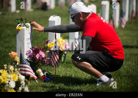 Arlington, Virginia, USA. 25th May, 2015. Larry Gonzales pauses at the grave of Stephen Mace in Arlington National Cemetery on Memorial Day May 25, 2015 in Arlington, Virginia. Credit:  Planetpix/Alamy Live News Stock Photo