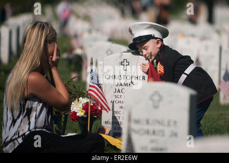 Arlington, Virginia, USA. 25th May, 2015. Christian Jacobs, 4, hugs the headstone of his father  U.S. Marine Corps Sgt. Christopher Jacobs as mother Brittany, wipes away a tear in Arlington National Cemetery on Memorial Day May 25, 2015 in Arlington, Virginia. Credit:  Planetpix/Alamy Live News Stock Photo