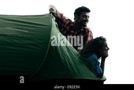 one caucasian couple trekker trekking camping tent nature in silhouette isolated on white background Stock Photo