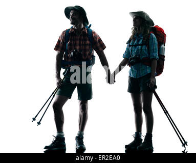 one caucasian couple trekker trekking nature in silhouette isolated on white background Stock Photo