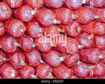 Salamis piled up in a shop Stock Photo