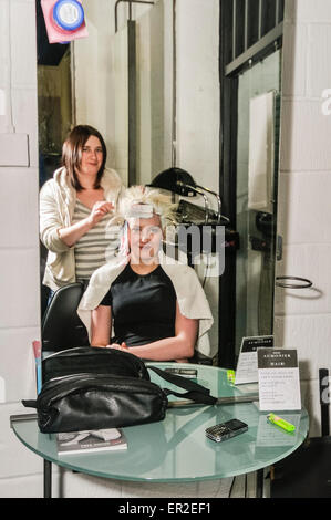 A girl has her hair dyed at a hairdressers. Stock Photo