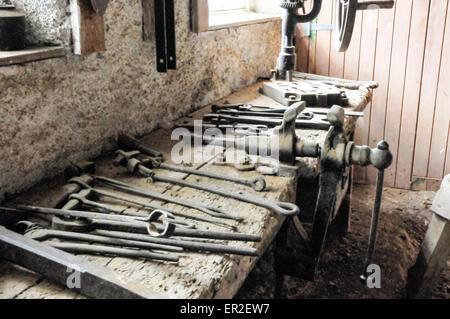 Metal tools in a blacksmith's forge. Stock Photo