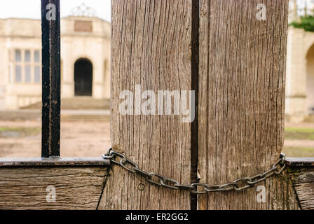 Chain locking a wooden gate outside a building. Stock Photo