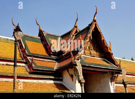 Bangkok, Thailand:  Step gabled roofs with chofah ornaments over the cloister gallery at Wat Suthat Stock Photo