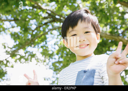 Japanese young boy in a city park Stock Photo