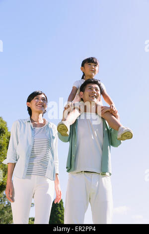 Happy Japanese family in a city park Stock Photo