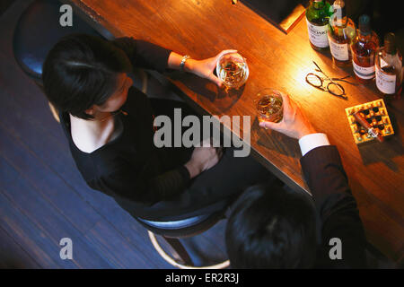 Couple drinking in a fashionable bar Stock Photo