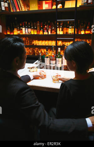 Couple drinking in a fashionable bar Stock Photo