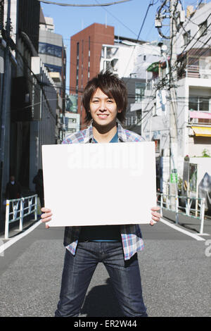 Young man with whiteboard Stock Photo