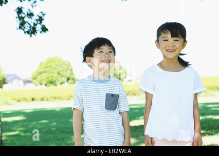 Happy Japanese kids in a city park Stock Photo