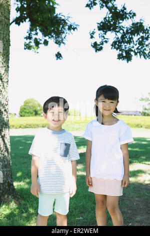 Happy Japanese kids in a city park Stock Photo