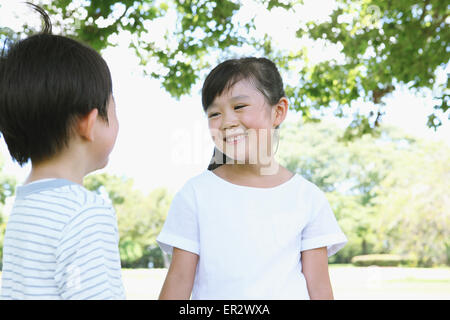 Happy Japanese kids in a city park Stock Photo