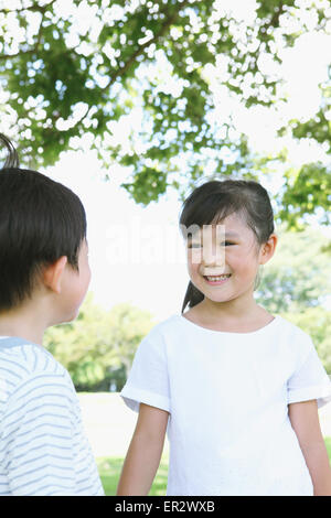 Happy Japanese kids in a city park Stock Photo