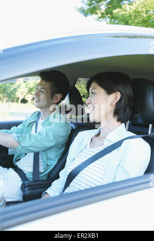 Japanese couple riding a car in nature Stock Photo