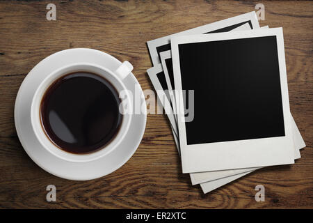 coffee cup and polaroid photo frames on table Stock Photo