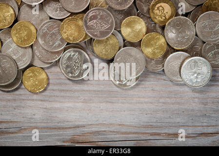 Top view coins on old wooden desk with copy space on bottom. Stock Photo