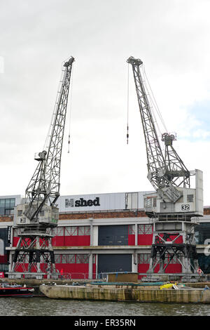 Preserved  electrically powered cargo cranes outside the M Shed museum on the harbour front in Bristol, UK. Stock Photo