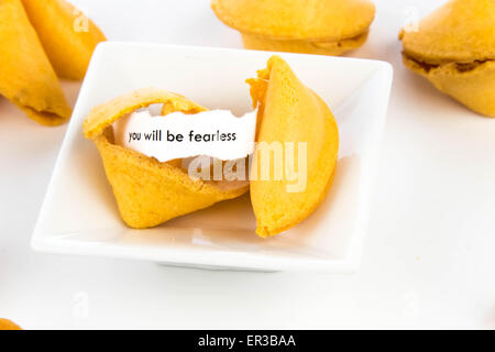open fortune cookie with strip of white paper - YOU WILL BE FEARLESS Stock Photo